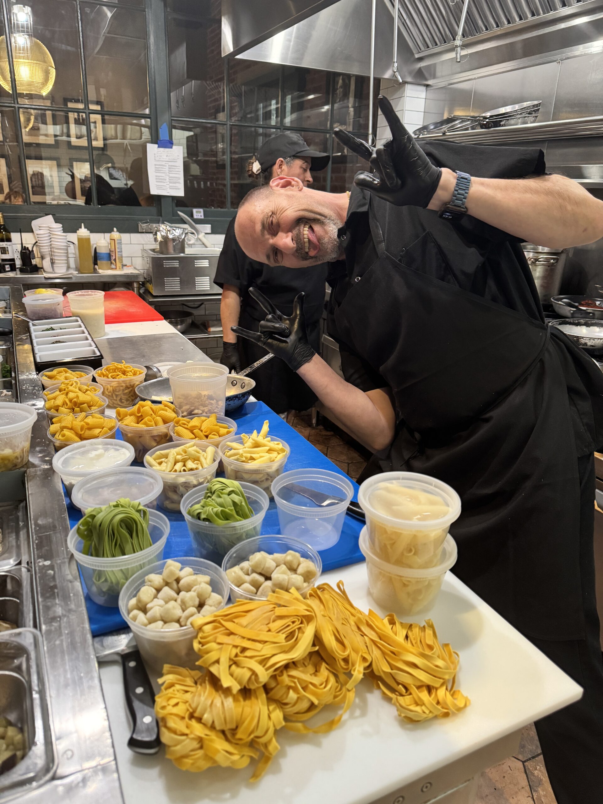 Chef Maurizio Peccolo smiling near plated food